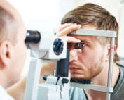A man getting his eyes checked with eye examination equipment
